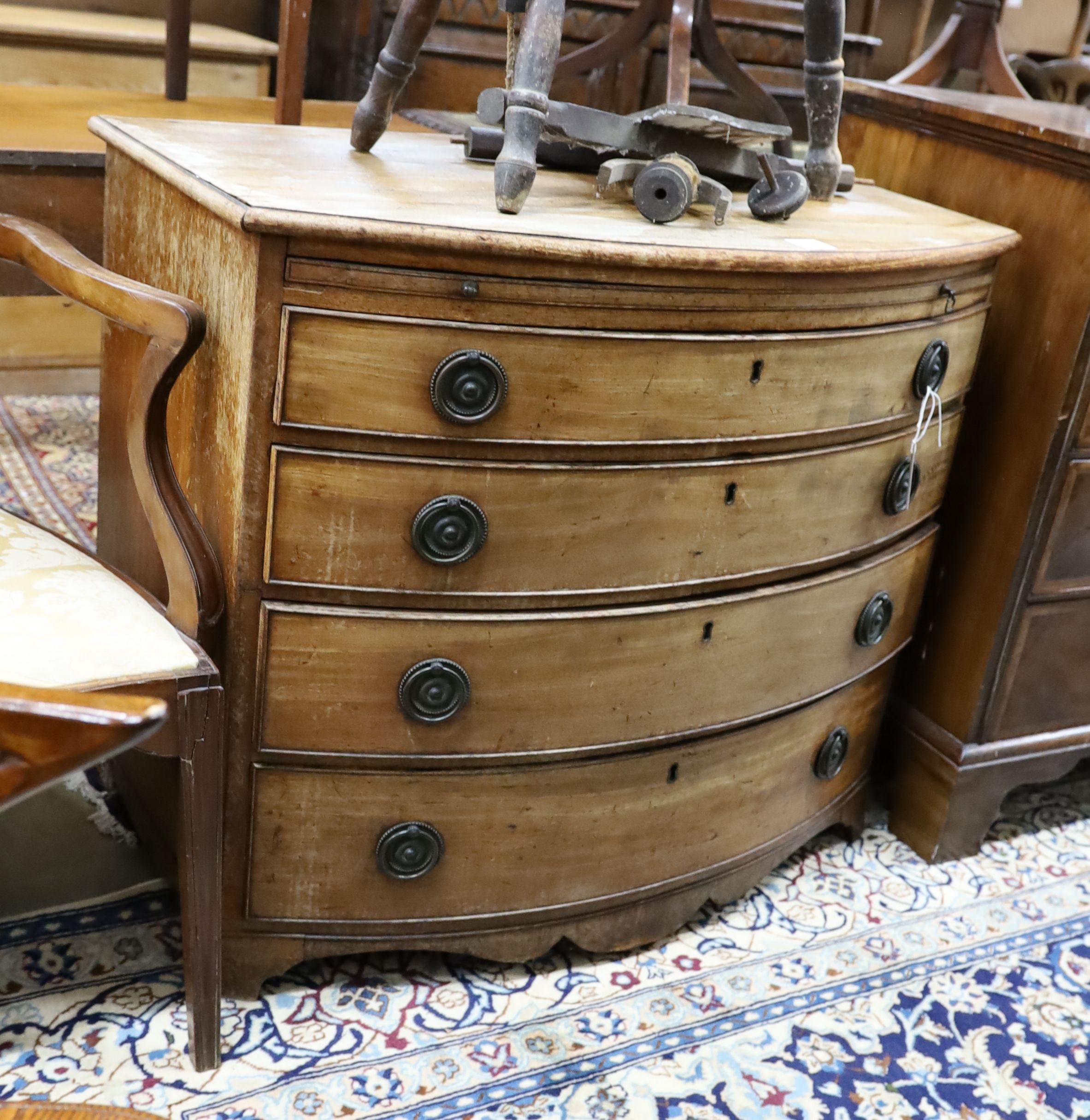 A Regency mahogany bow front chest of drawers with brushing slide, width 92cm, depth 56cm, height 80cm